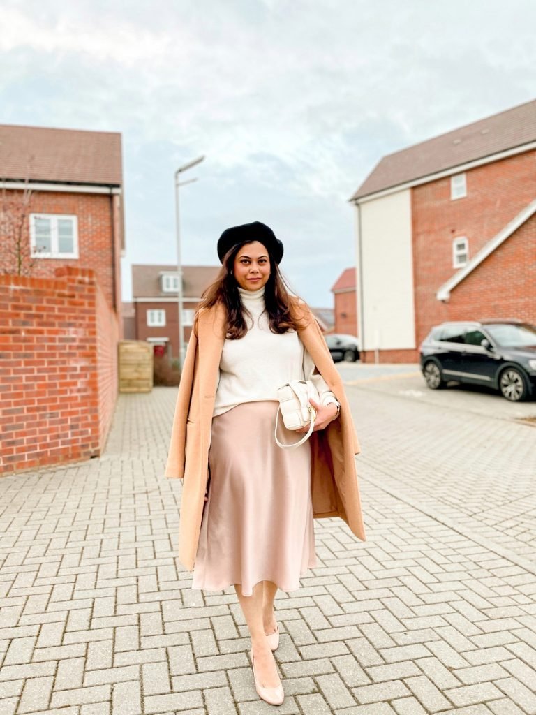 Satin midi skirt in beige with beret white jumper and camel coat and Bottega Veneta bag | Colour me in style