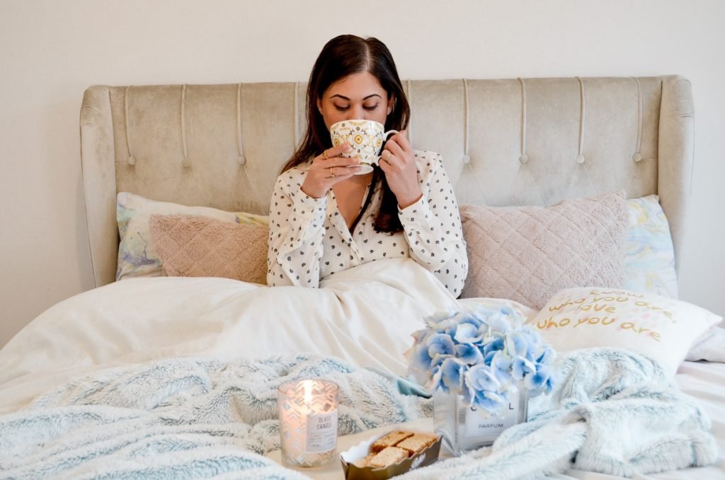 Girl and coffee picture. Romantic date idea for lockdown, please your wife with some breakfast in bed , betty's tea and biscuits candles and some beautifully decorated flowers 