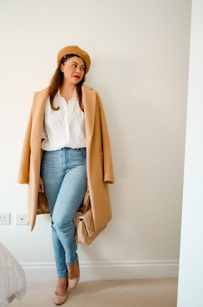 Camel coat and beret with classic white shirt and blue jeans 