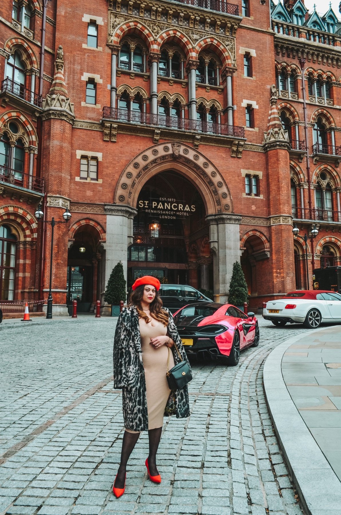 ST. PANCRAS RENAISSANCE HOTEL LONDON
Woman with red Ferrari in fur coat and parisian style outfit . Knit dress and Red beret. Instagrammable spot in london St Pancras  London.
