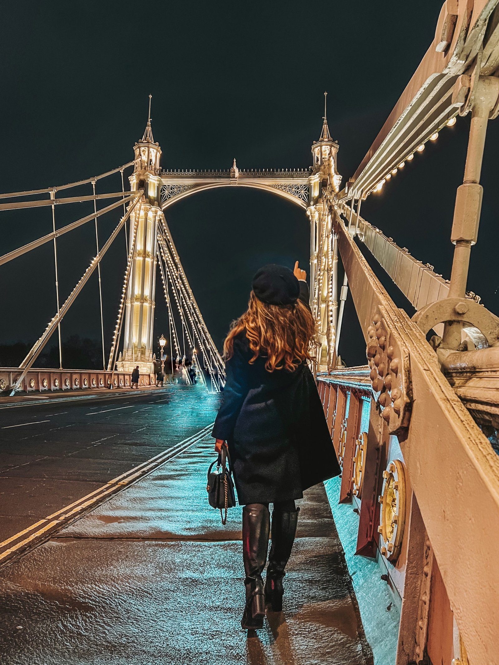 Albert Bridge Chelsea . Girl in Boots and Black coat on London Bridge.
Most Instagrammable spots in London 