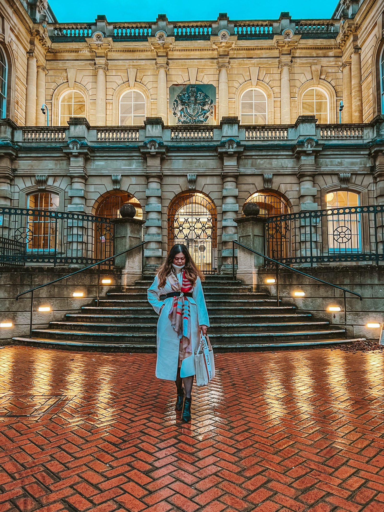 London style winter outfit with Burberry scarf and long white coat with winter boots.