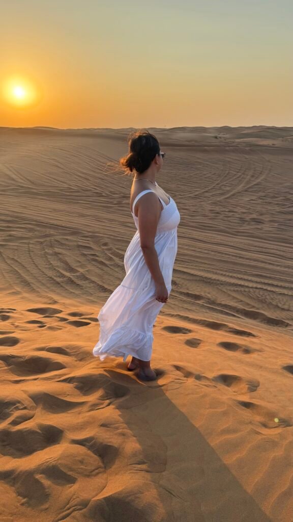 A woman looking out to the desert at a desert safari in Dubai  