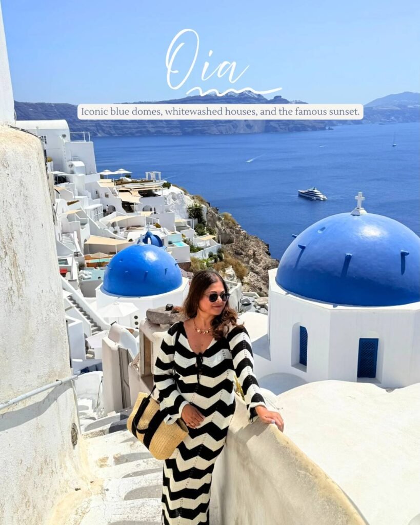 Pooja standing on the famous staircase view point of the 3 blue dome church in Oia , Santorini