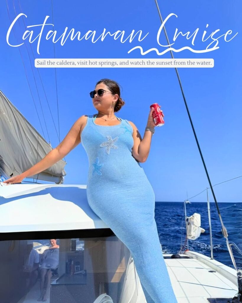 Pooja standing on a the front of the boat in her blue knit dress during a Catamaran cruise