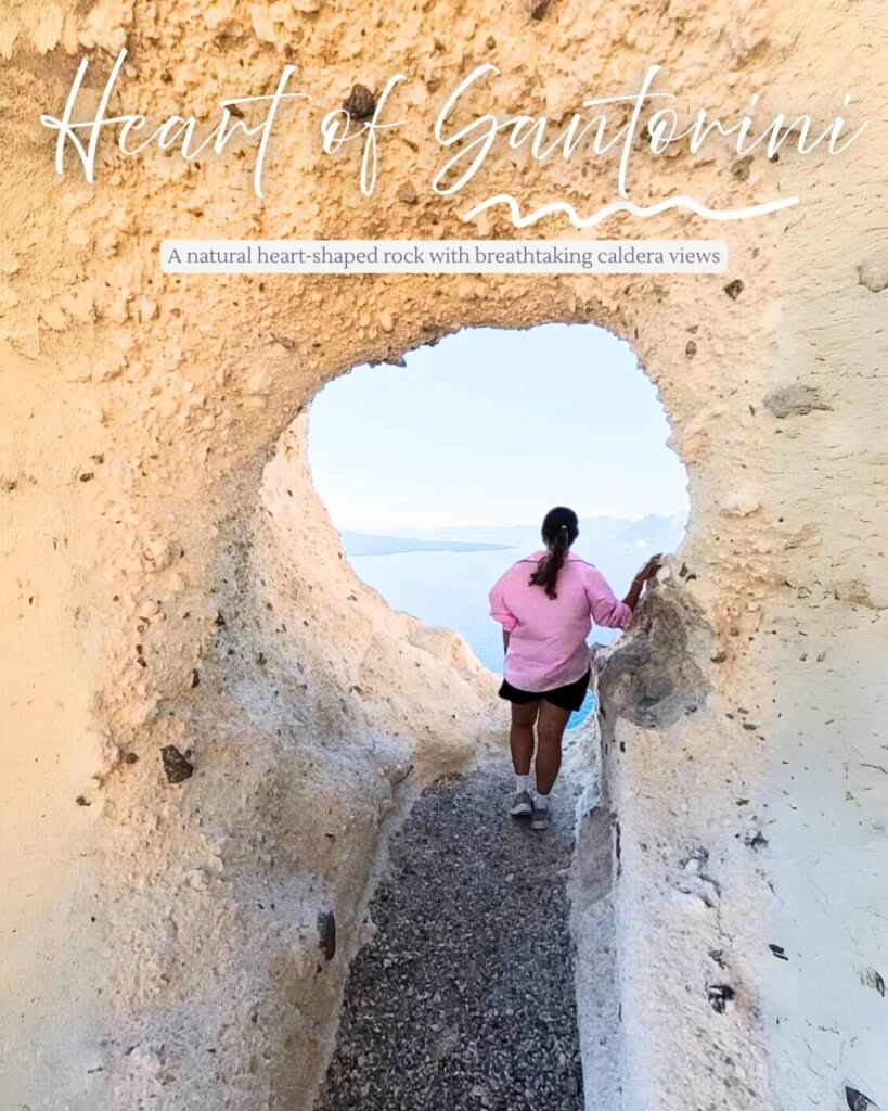 A woman looking through the white cliffs of the heart of Santorini view point.
