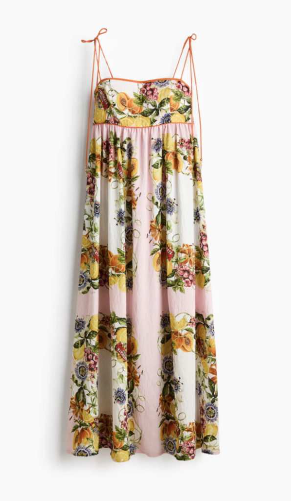 An ankle-length dress crafted from a soft viscose-blend fabric, featuring a striking placement print. Designed with a fitted bodice and a clean straight neckline, it has delicate tie-up shoulder straps and a comfortable smocked panel at the back. 