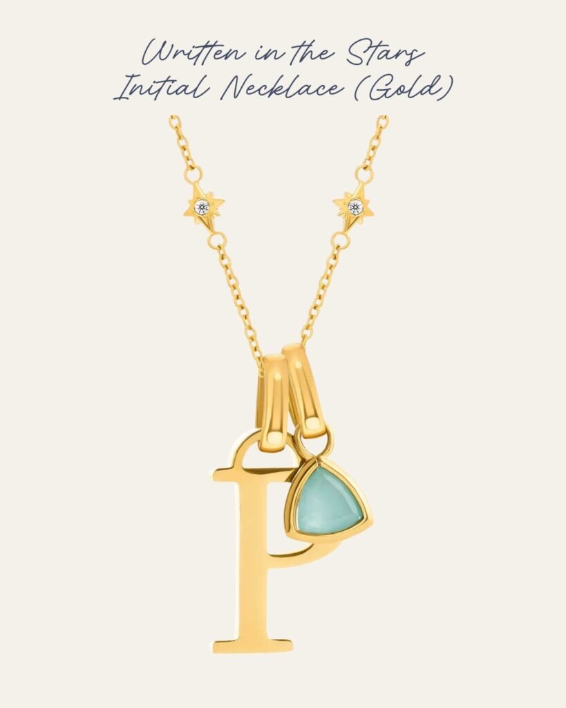 Written in the Stars Initial Necklace. Crafted with 18k gold plating, its delicate chain is dotted with tiny, twinkling stars. The chain has a gold plated P and a birthstone in turquoise. 